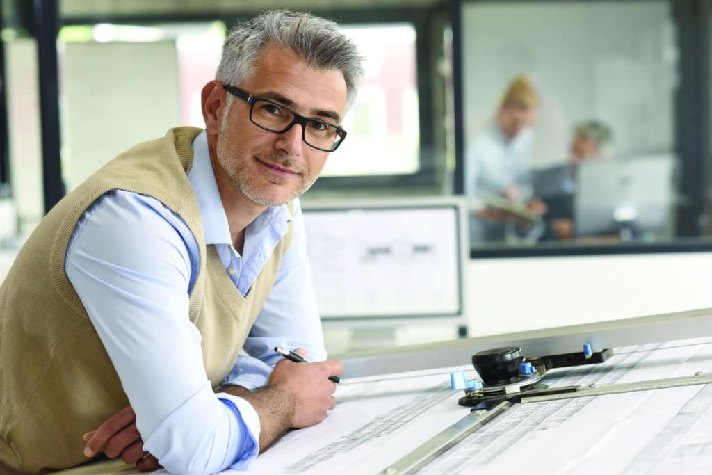 Architect sitting at drawing table in office